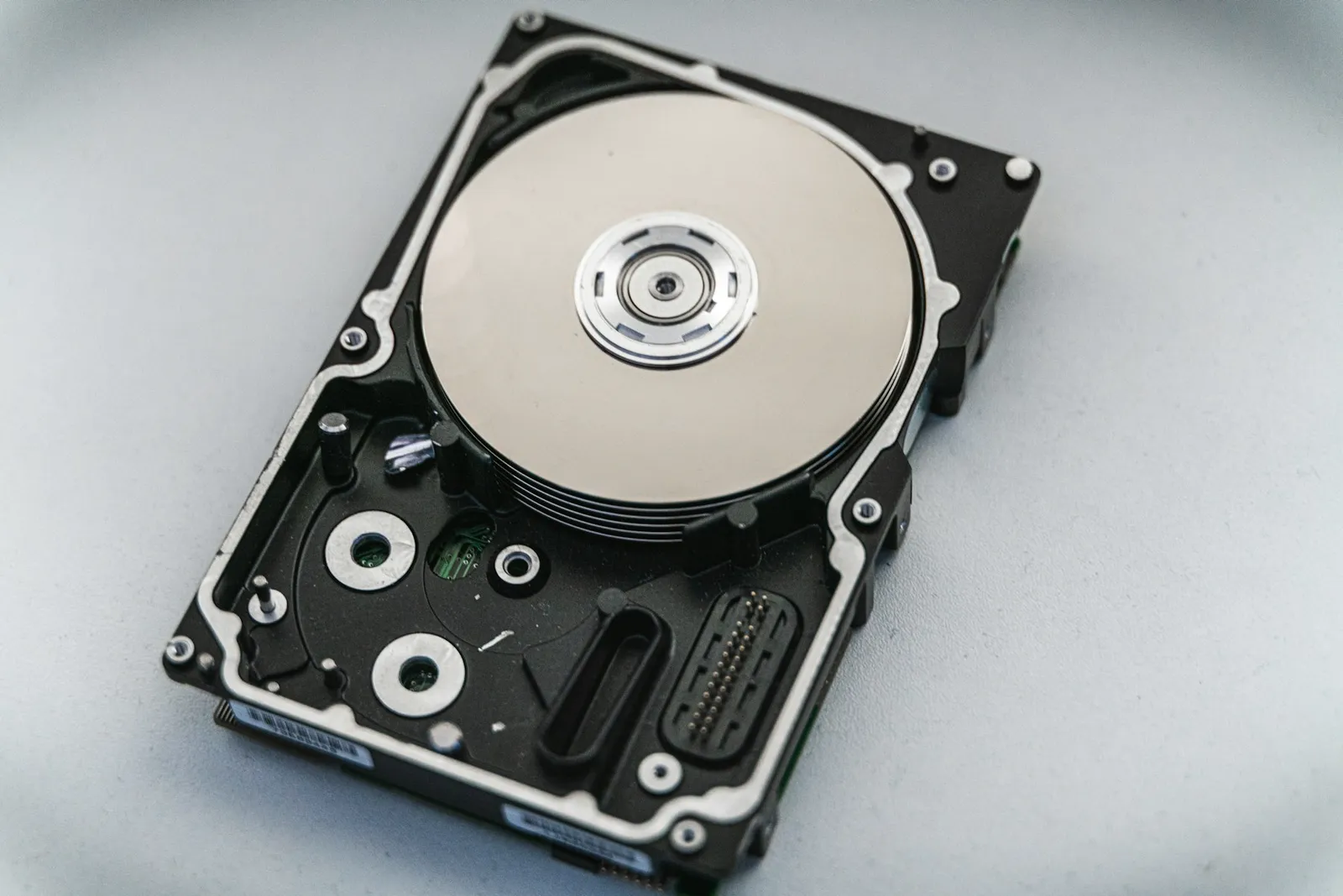Open hard disk drive on a light surface